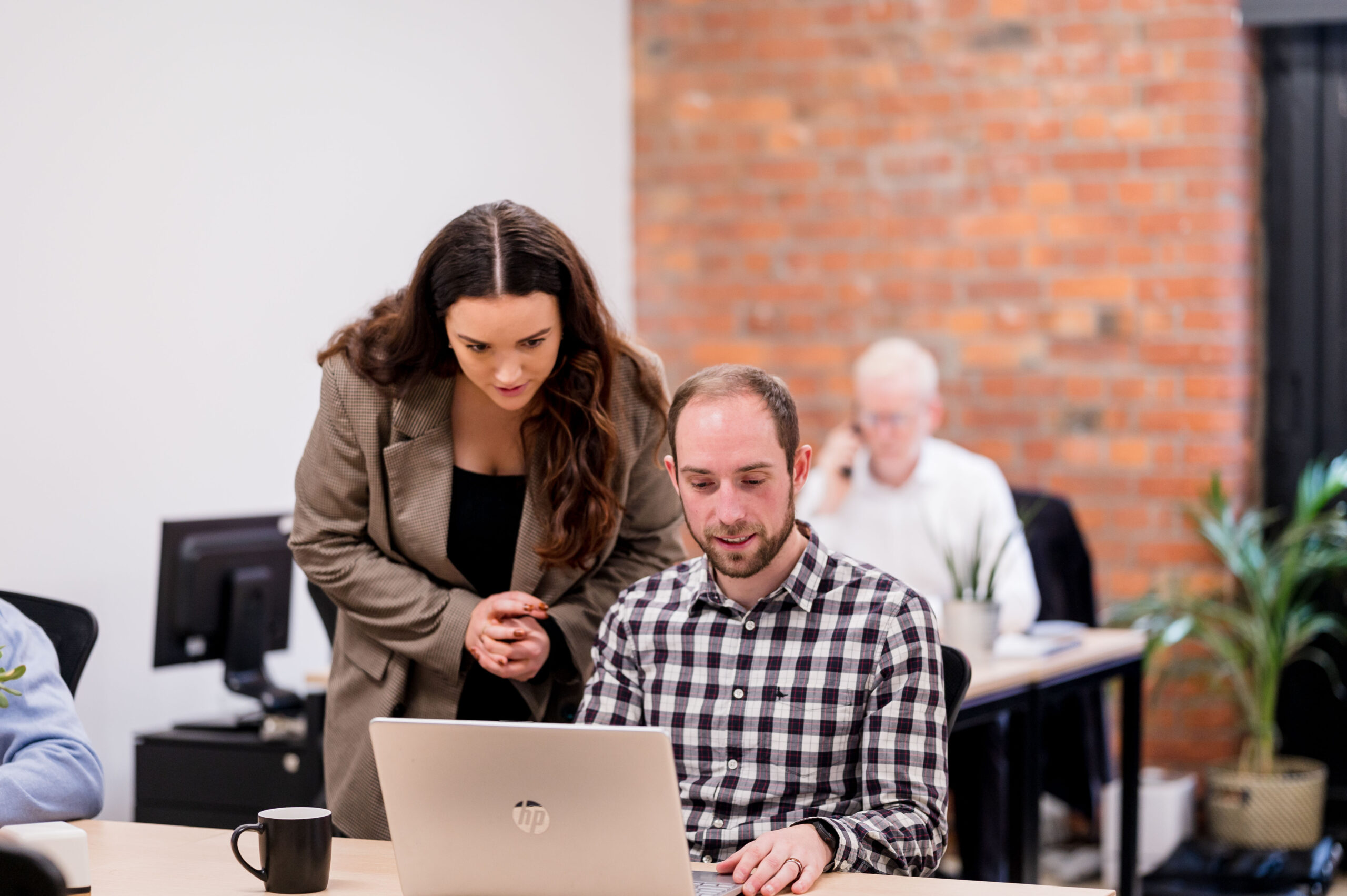 Showing colleague work on laptop