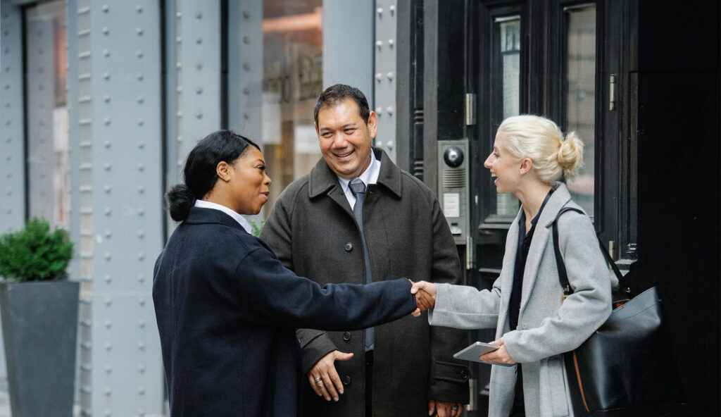 Two females greeting eachother with handshake