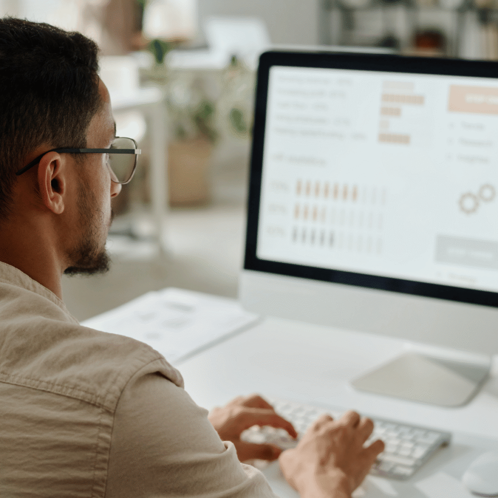 man conducting whole life carbon assessment on computer